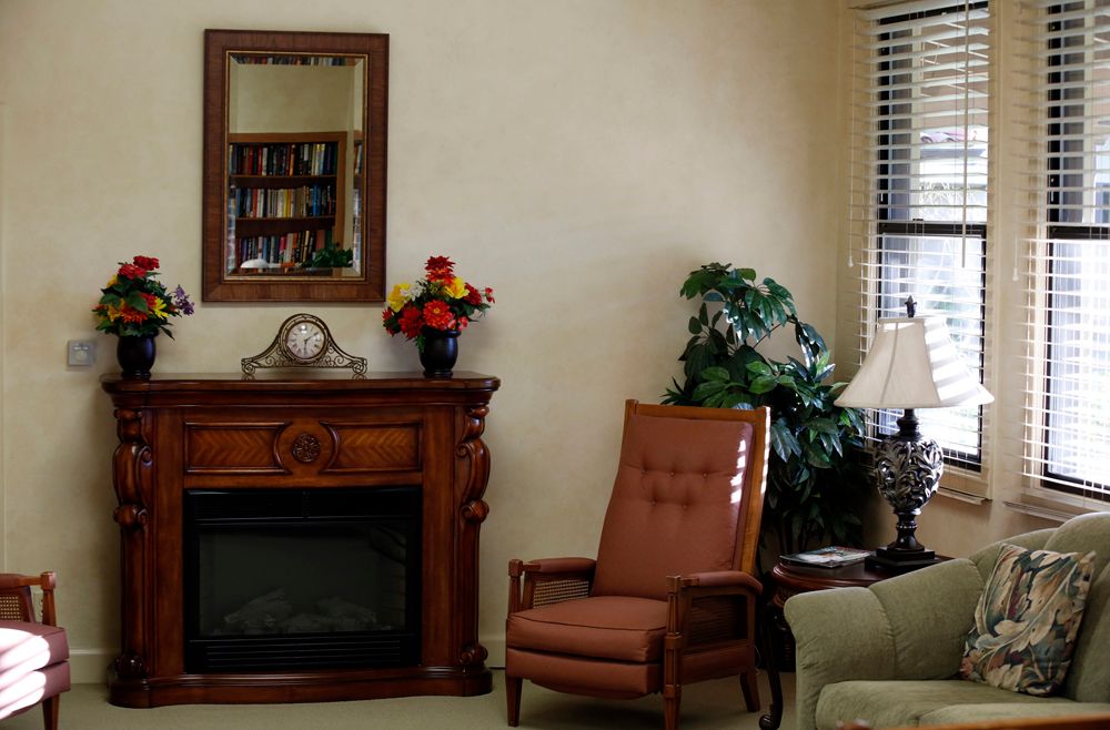 A cozy living room with a comfortable chair, fireplace, and decorative elements.