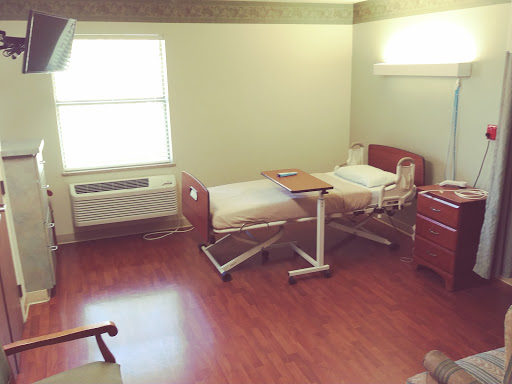 A hospital room equipped with a patient bed and essential medical furnishings.