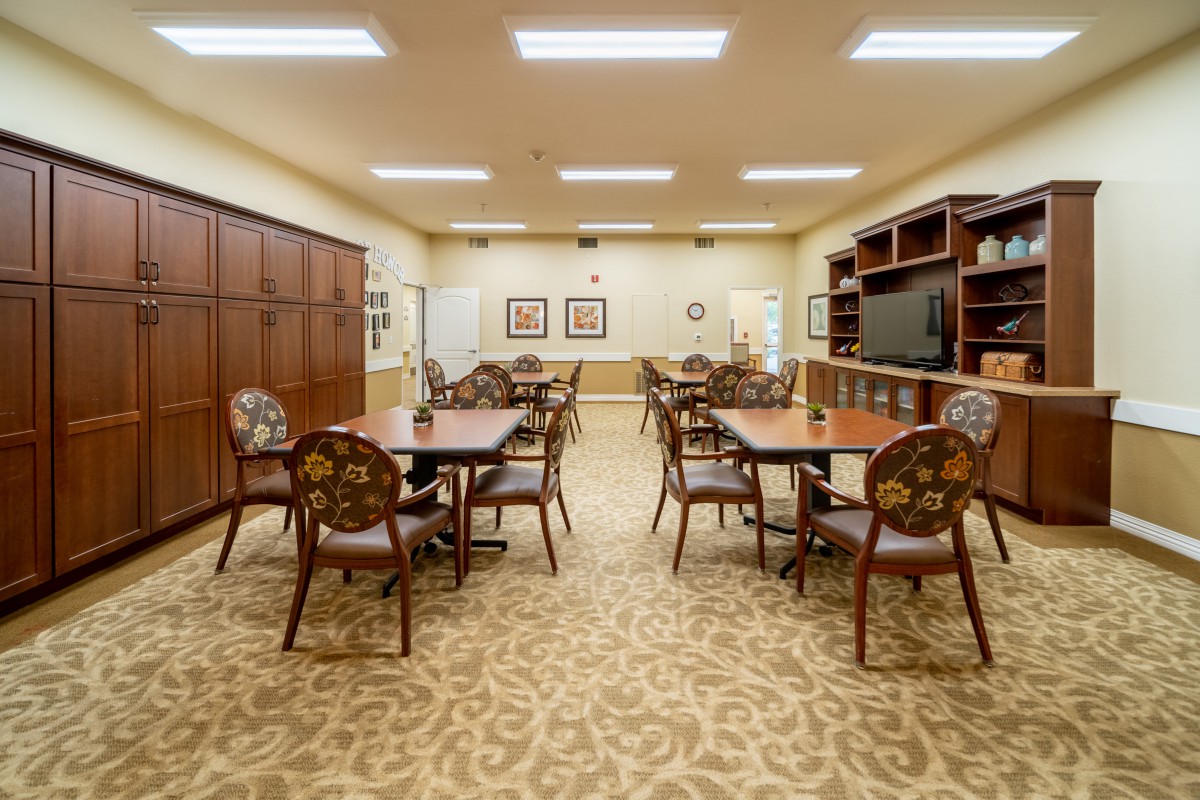 A well-organized conference room with multiple tables and chairs arranged for meetings.