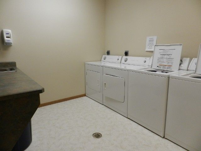 A clean and organized laundry room with a washer and dryer setup.