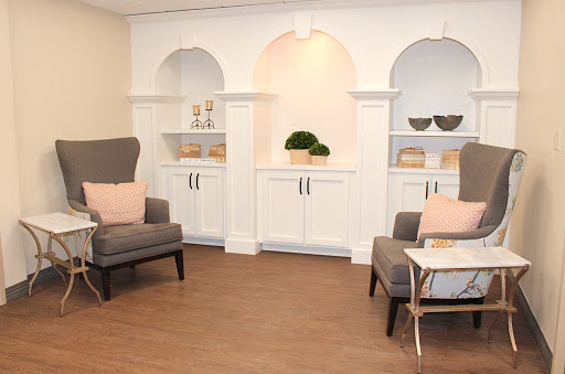 A modern living room setup featuring comfortable seating and elegant shelving.