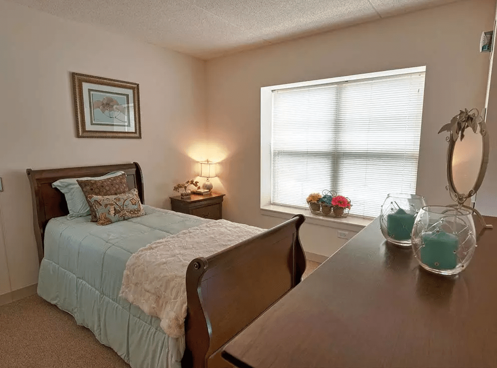 A cozy bedroom with a single bed and soft lighting.