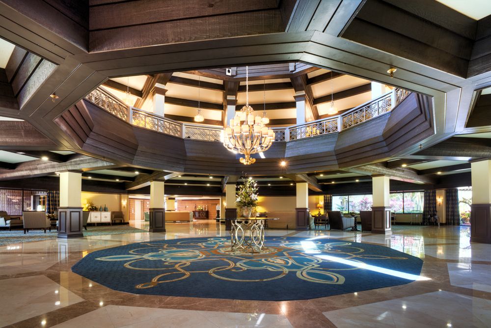 A luxurious hotel lobby featuring a grand chandelier and elegant interior design.