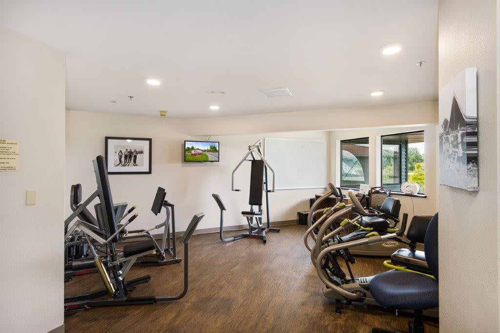 A well-equipped gym with various exercise machines.