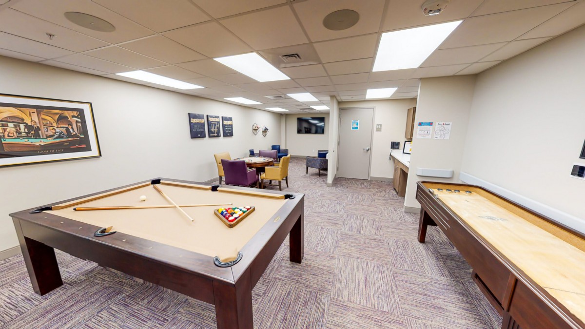 A recreational space featuring pool tables and a seating area for relaxation.