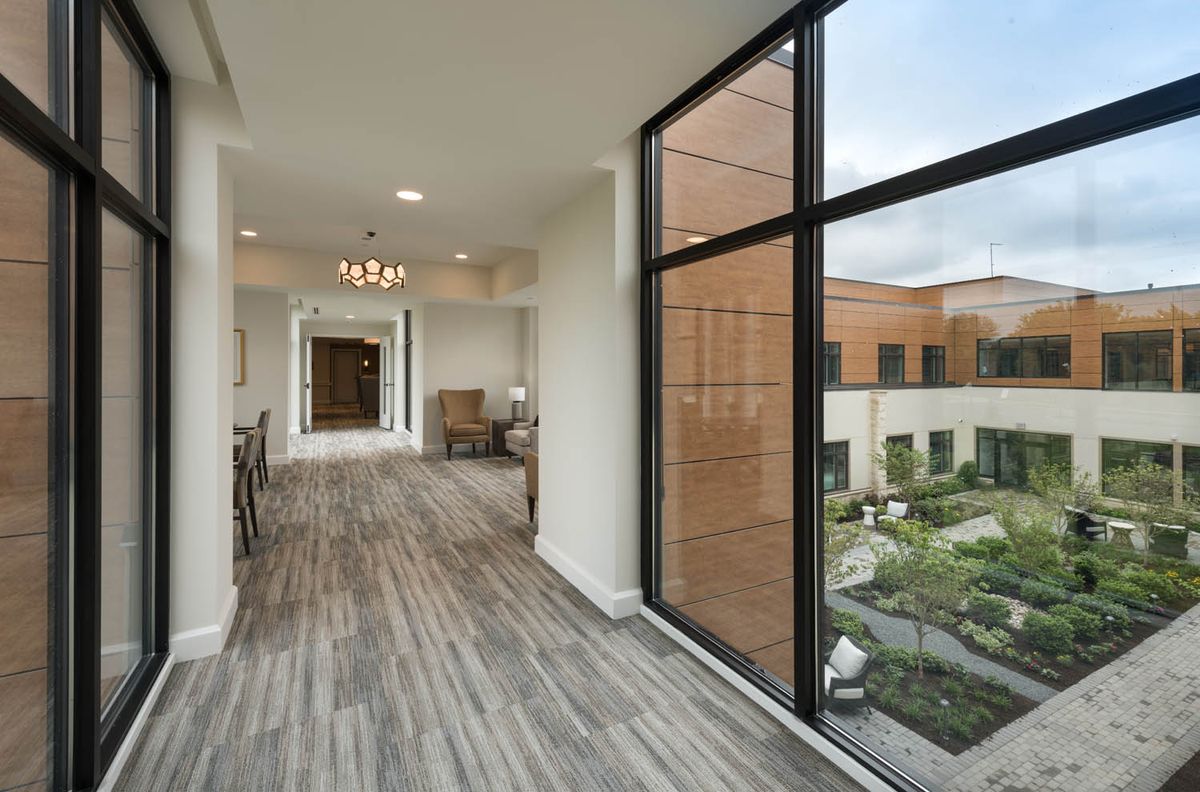 A modern hallway with large windows and natural light.