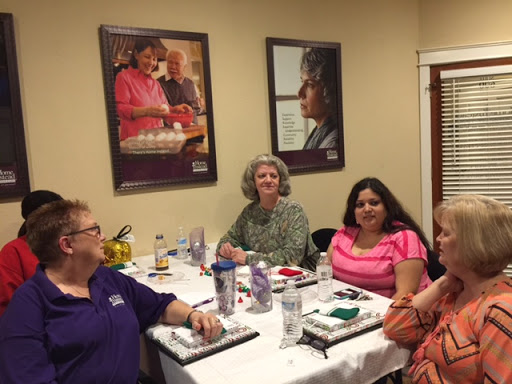 A group of individuals gathered around a table engaged in conversation.