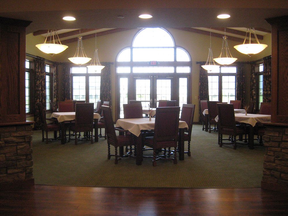 Spacious dining area with large windows and elegant lighting.