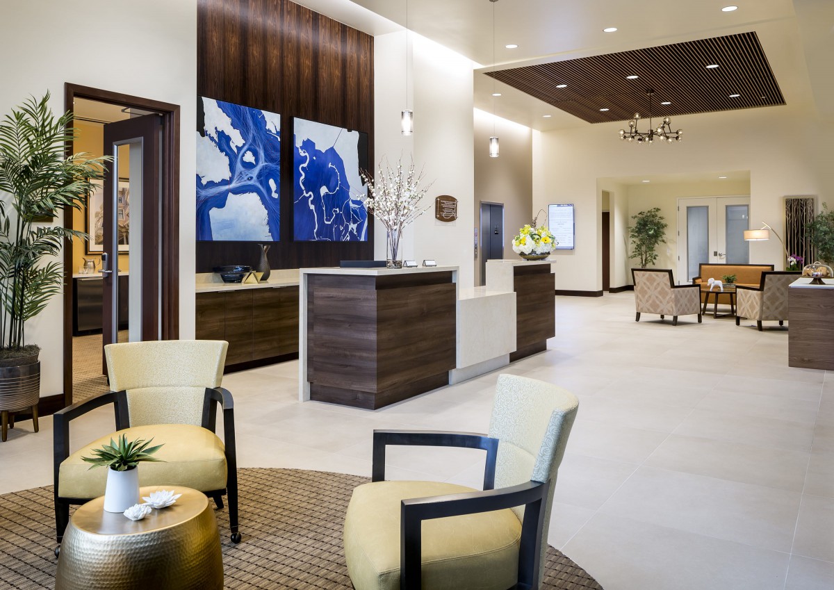A modern lobby with comfortable seating and abstract artwork on the walls.