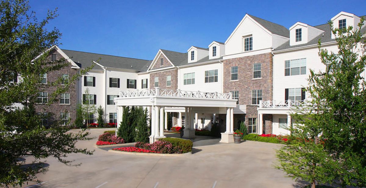 A classic hotel exterior with landscaped entrance.