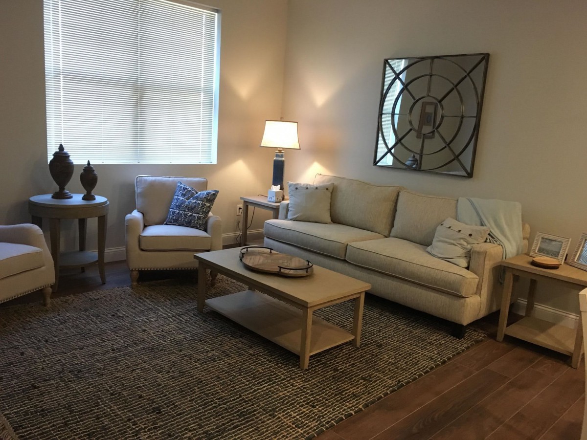 A cozy living room with modern furniture and warm lighting.