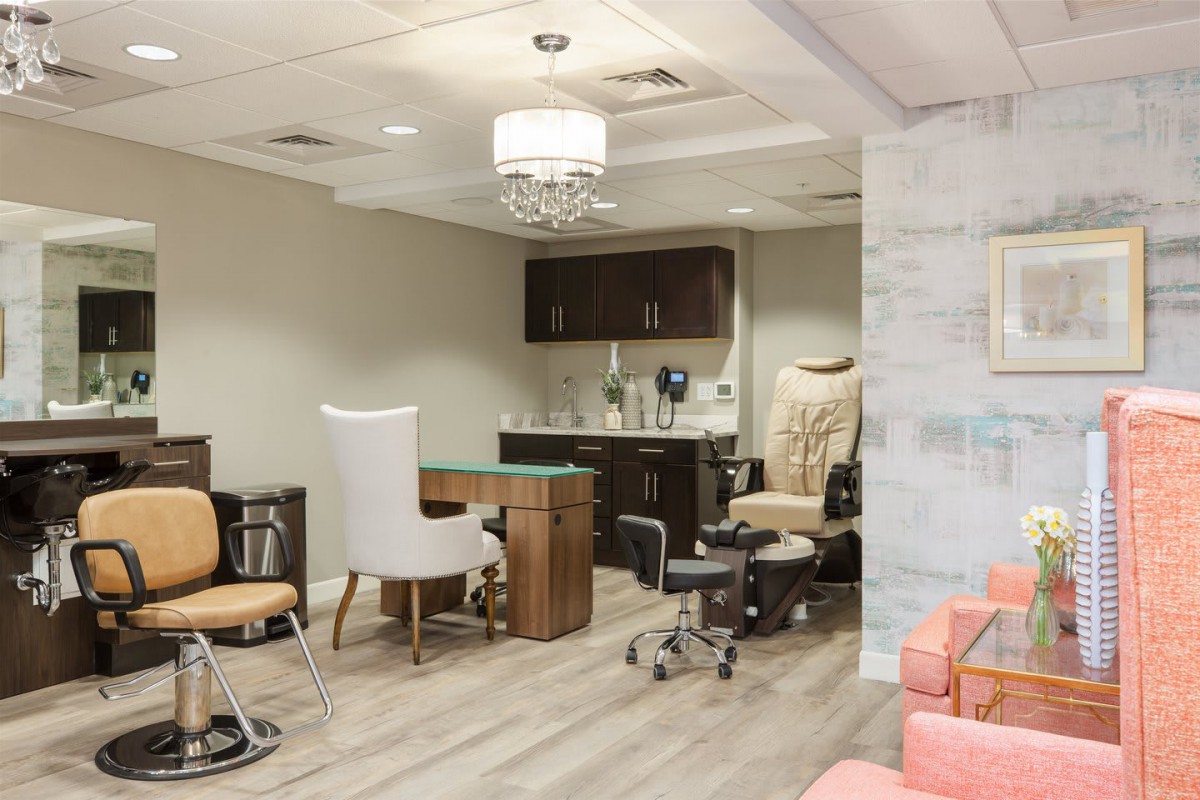 A cozy nail salon interior with manicure and pedicure stations.