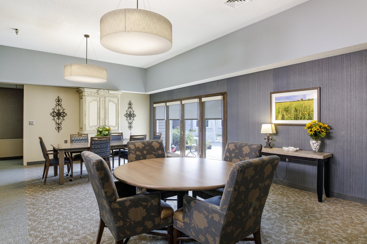 A modern meeting room with a round conference table and stylish lighting.