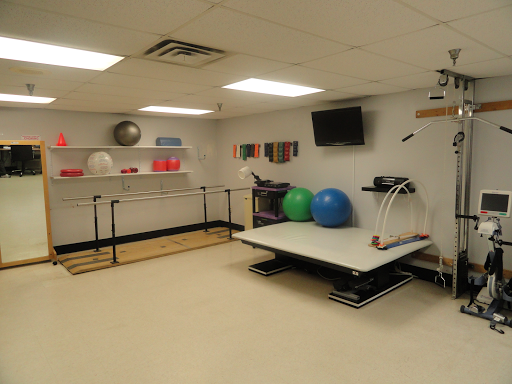A well-equipped physical therapy room featuring various exercise tools and equipment.