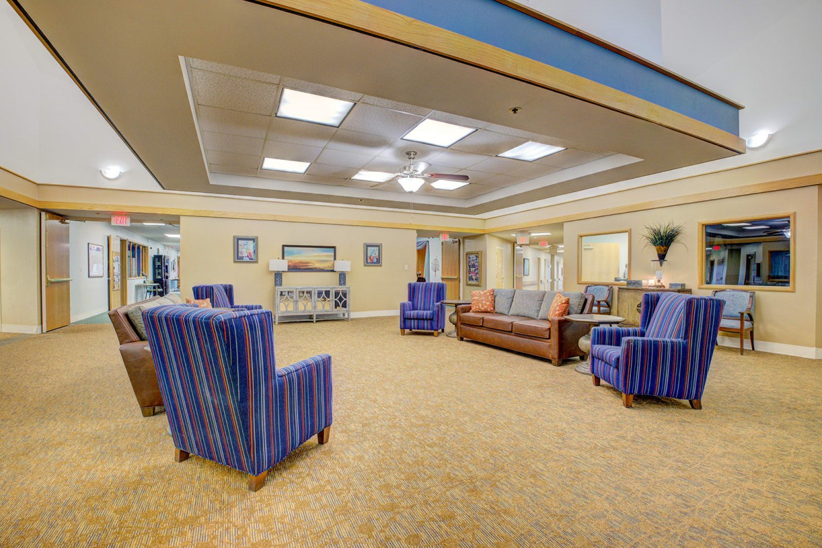 A spacious and well-lit lobby area featuring comfortable seating and elegant interior design.
