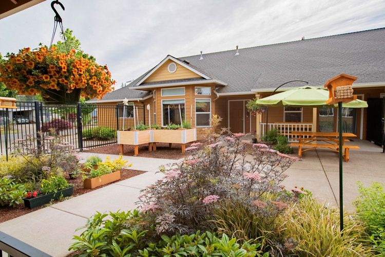 A charming residential home with a well-maintained garden and patio area.