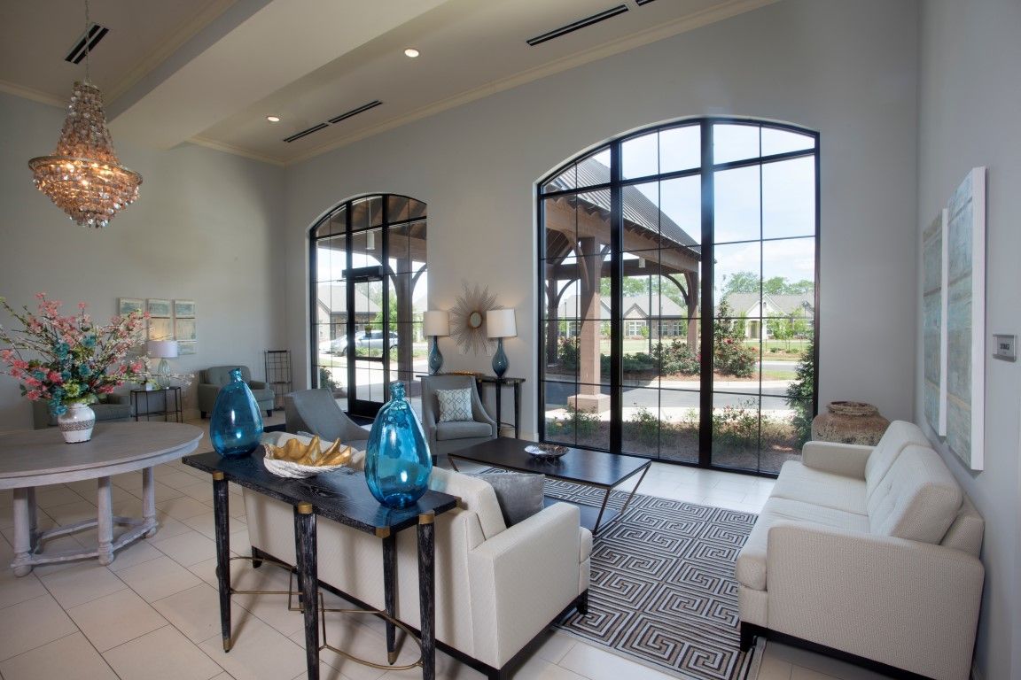 A modern living room with large windows and stylish furnishings.