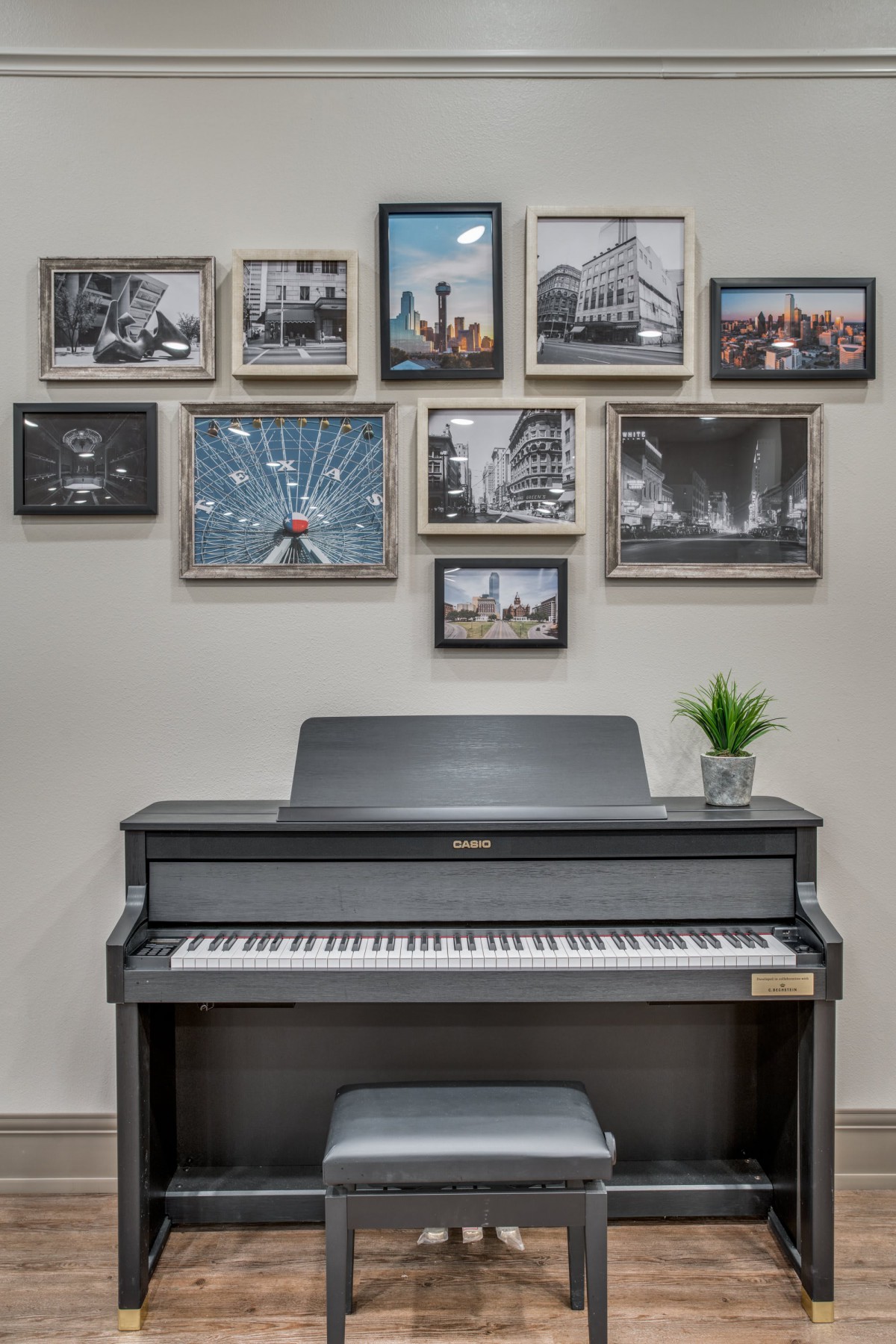 A stylish music room featuring a piano and a wall of framed photographs.