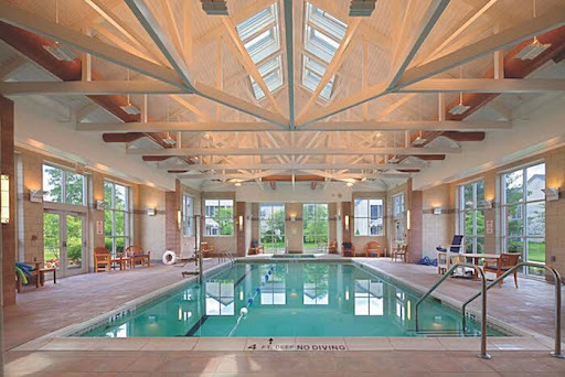 A beautifully designed indoor pool area, featuring high ceilings and ample natural light.