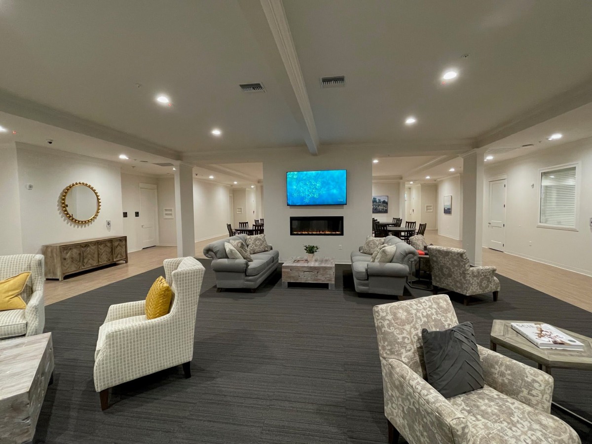 A modern living room with comfortable seating and a mounted television.