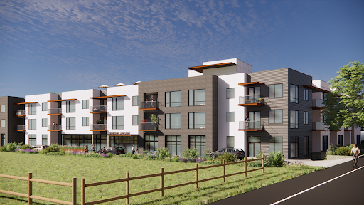 A modern residential building set against a clear blue sky.