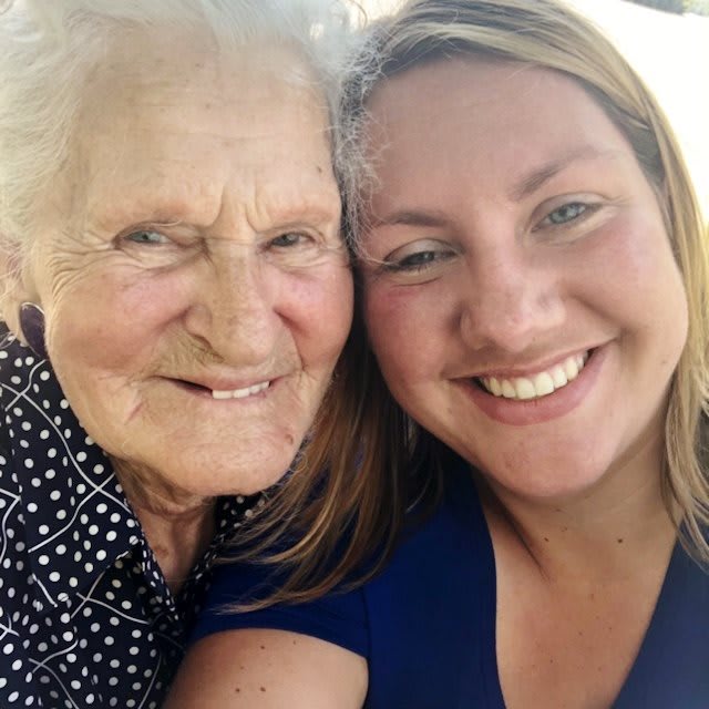 A selfie of two smiling women, likely family members, enjoying a moment together outdoors.