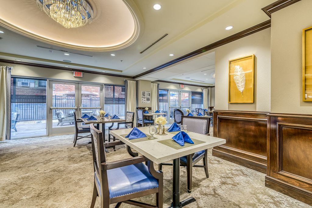 An elegant dining area with modern decor, featuring neatly arranged tables, contemporary furnishings, and decorative artwork.