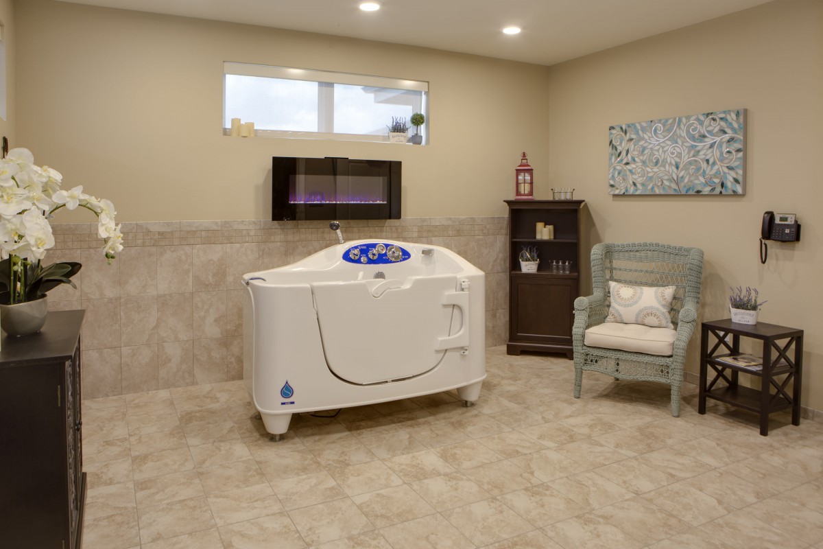 A spacious and modern bathroom featuring a specialized bathtub designed for relaxation and wellness.