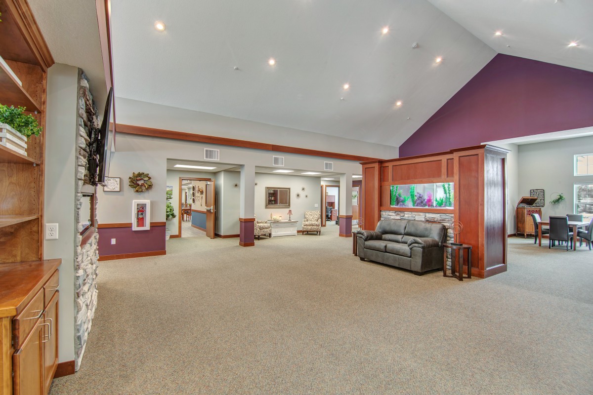 Spacious living room with modern decor and artwork.