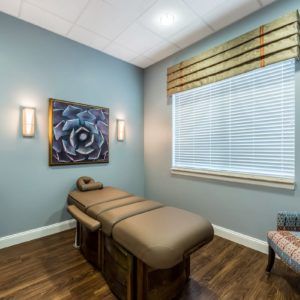 A tranquil massage room with soothing decor and a comfortable massage table.