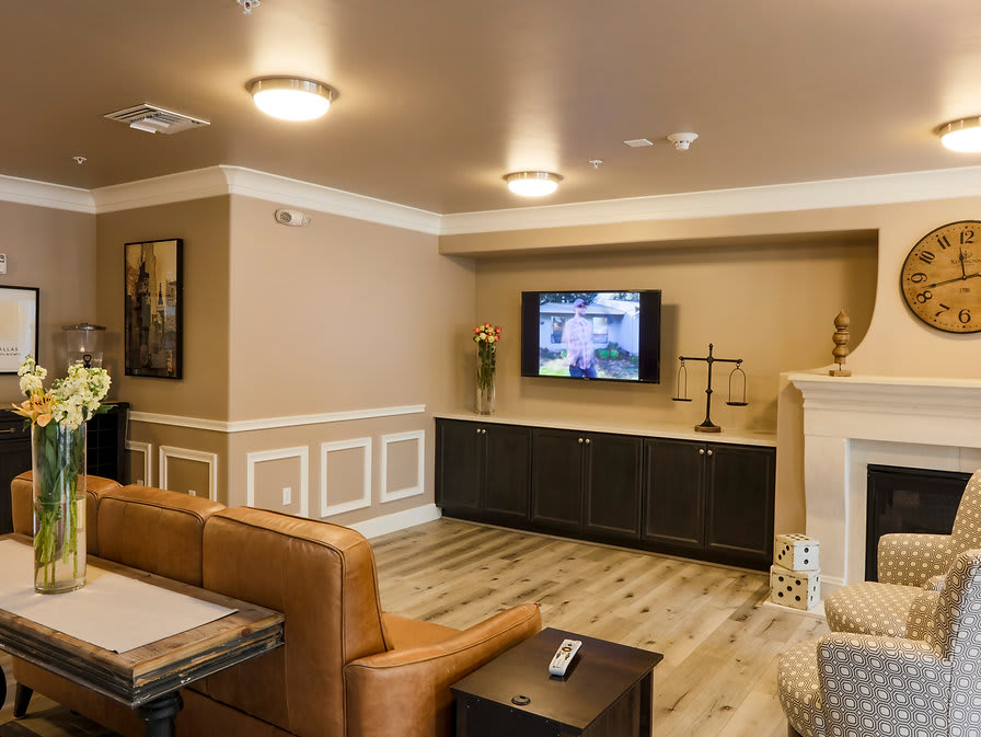 A modern living room with a comfortable couch and a wall-mounted TV.