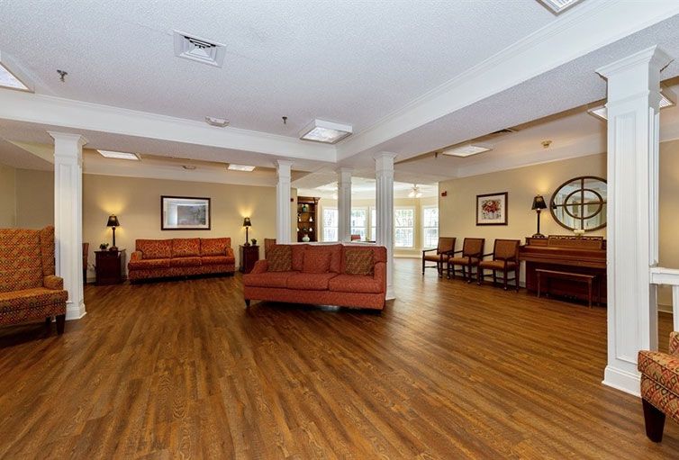 A spacious lobby with comfortable seating and wooden flooring.