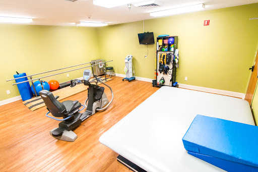 A well-equipped rehabilitation gym featuring various exercise and therapy equipment.