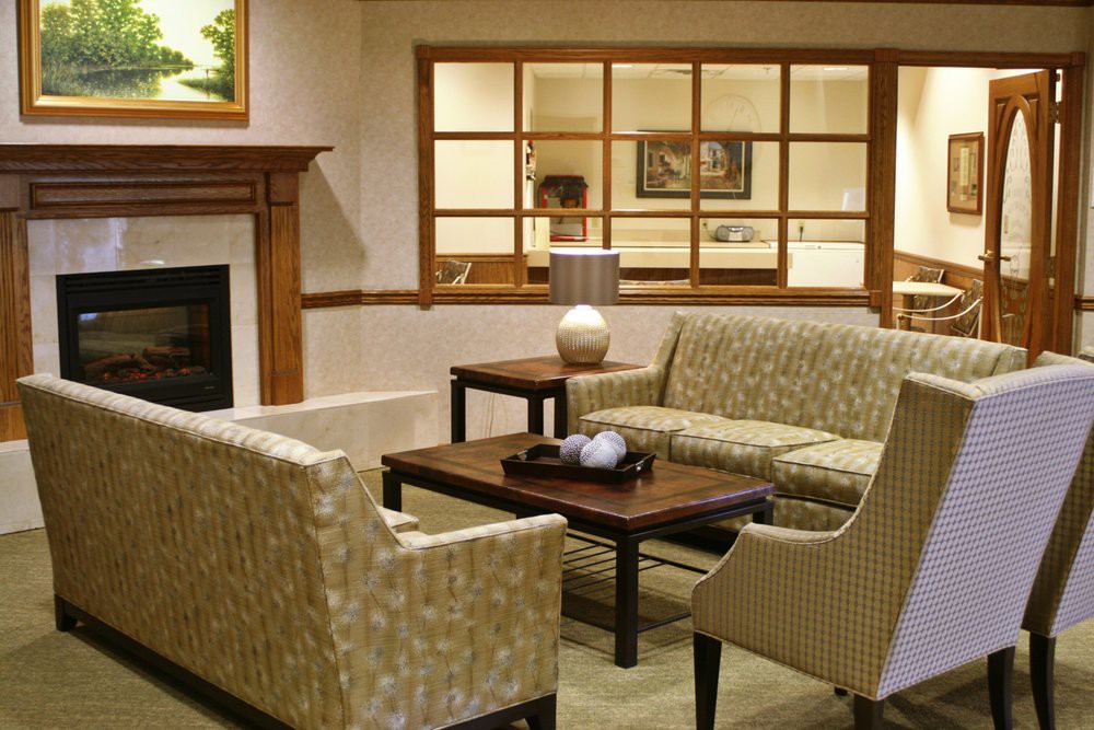A cozy living room with a sofa set, coffee table, and fireplace.
