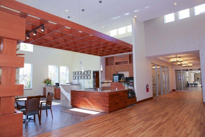 A modern reception area featuring wood accents and abundant natural light.