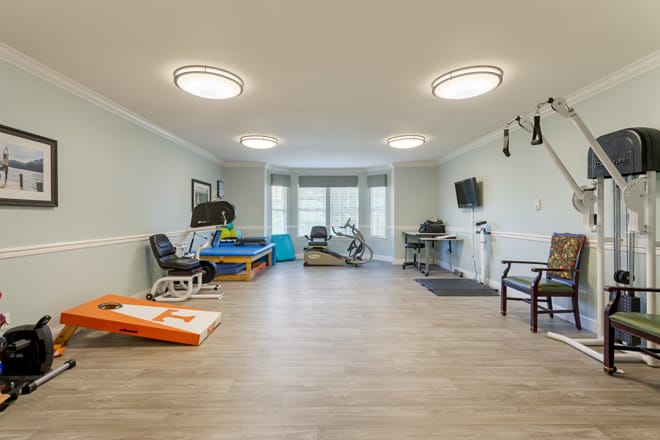 A spacious exercise room equipped with various fitness machines.