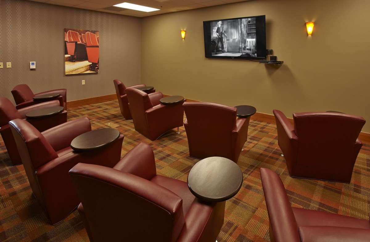A cozy home theater setup with comfortable seating and a large TV.