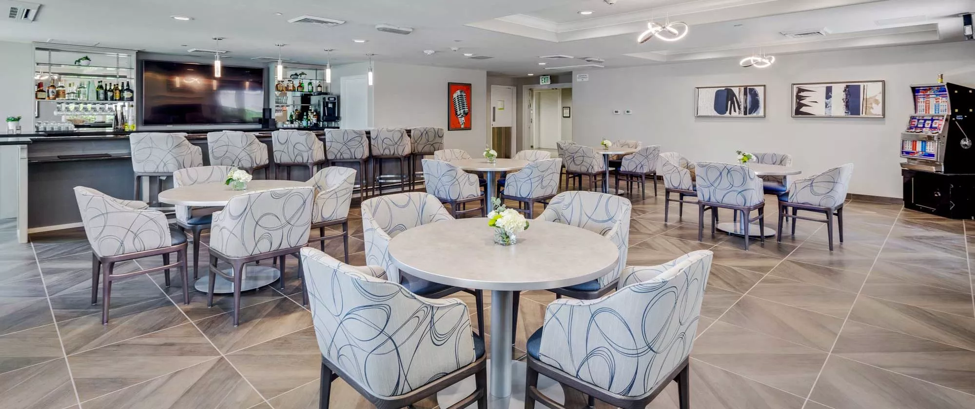 A modern and spacious dining area with neatly arranged tables and chairs.