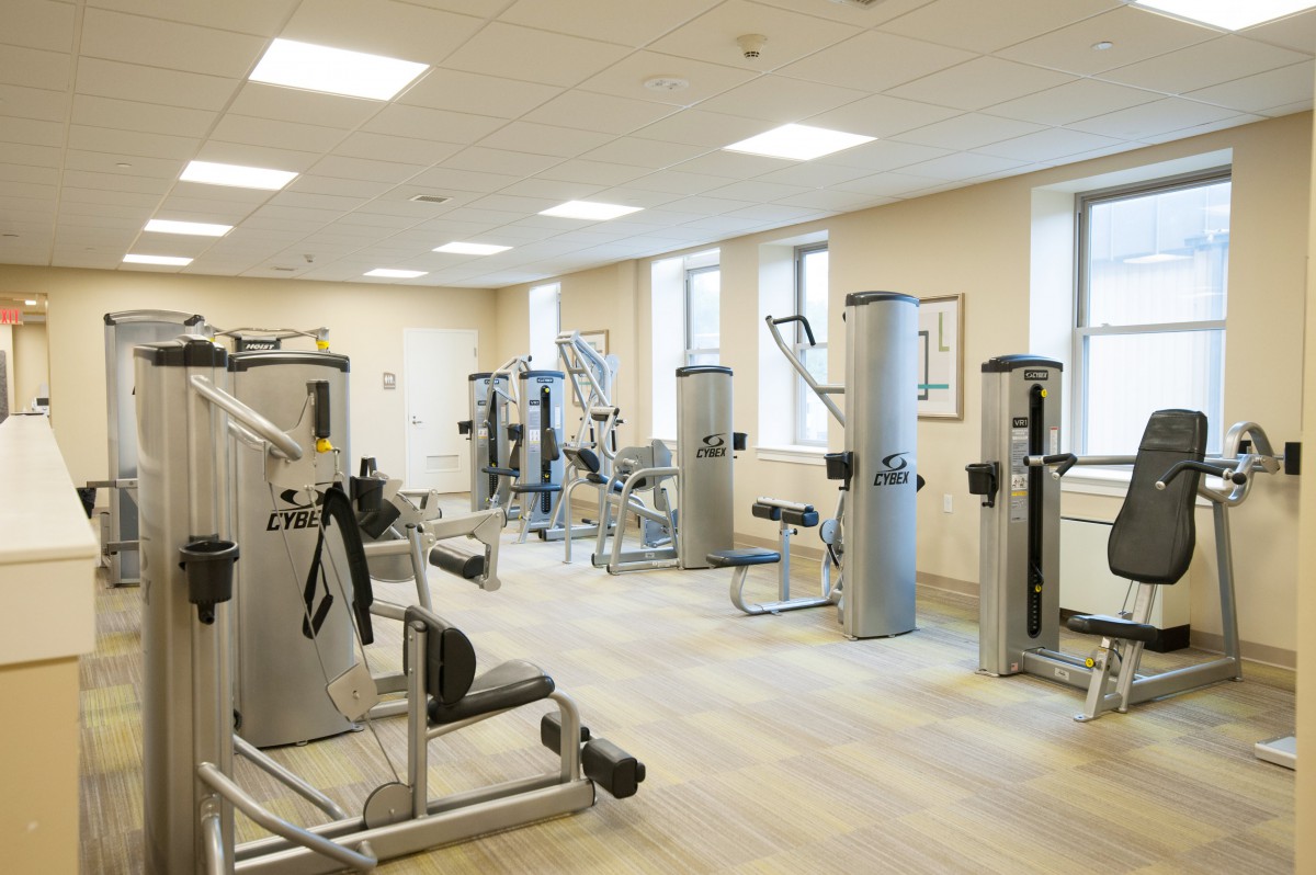 A spacious gym with various exercise machines and fitness equipment.