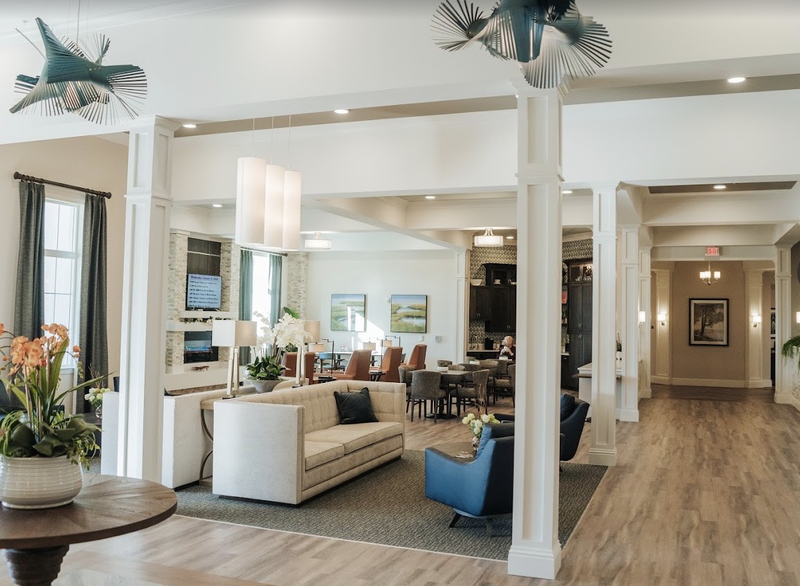 A modern and spacious living room with comfortable seating and elegant decor.