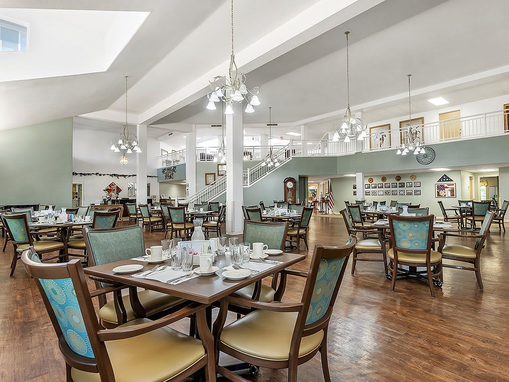 A spacious and elegantly designed dining area with neatly arranged tables and chairs.