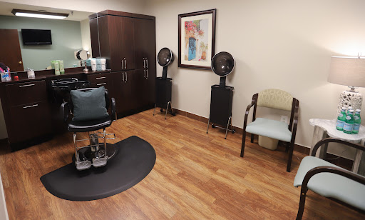 A cozy interior of a hair salon featuring styling chairs and hairdryers.