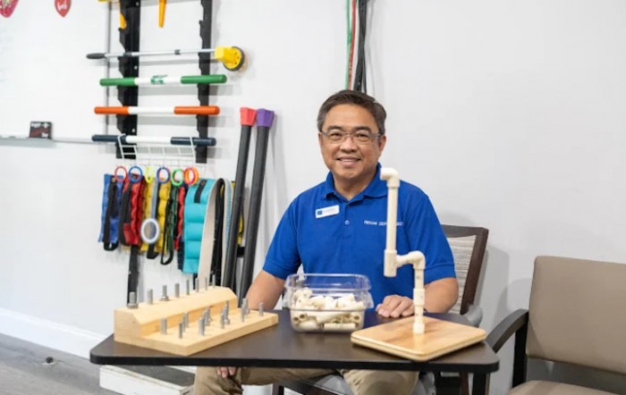 A man in a workshop setting, surrounded by tools and DIY projects.