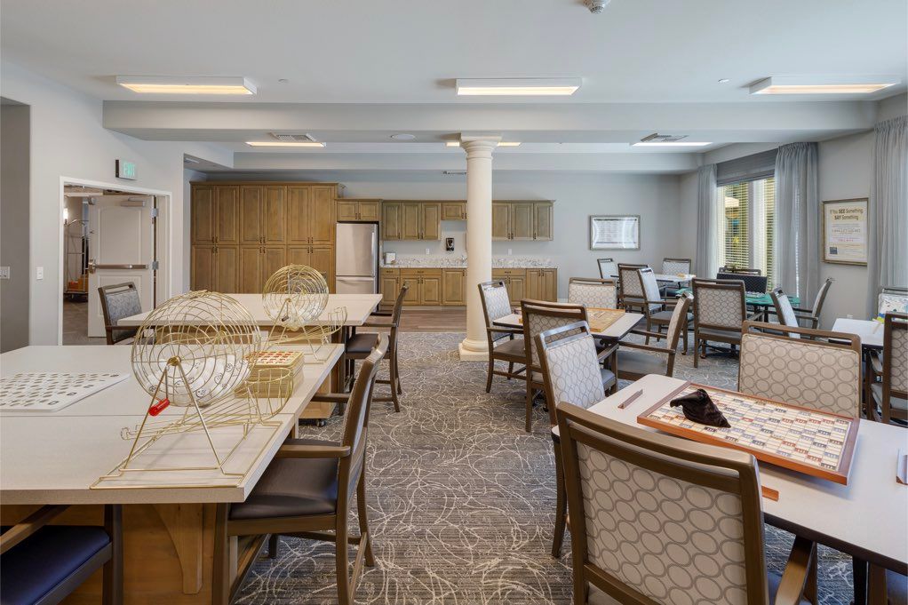 A modern conference room with multiple tables and chairs, featuring a clean and organized interior design.