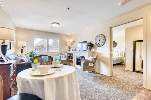 A cozy and bright living room with a dining area, featuring stylish furniture and decor.