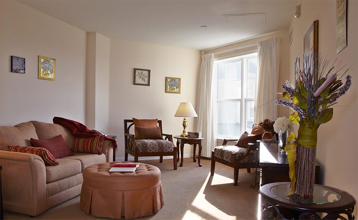 A cozy living room with traditional furniture and abundant natural light.