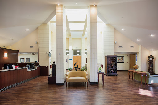 A modern and spacious lobby with bright lighting and elegant furniture.