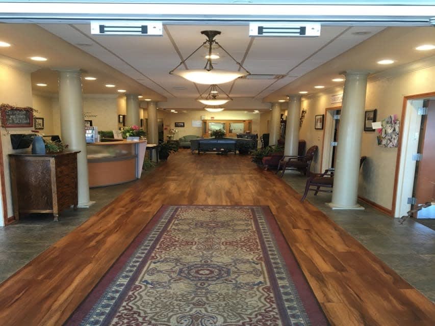A spacious and well-lit lobby area with a reception desk and comfortable seating.