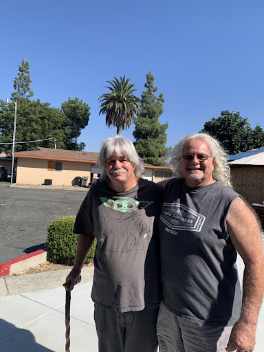 Two friends enjoying a sunny day outdoors.
