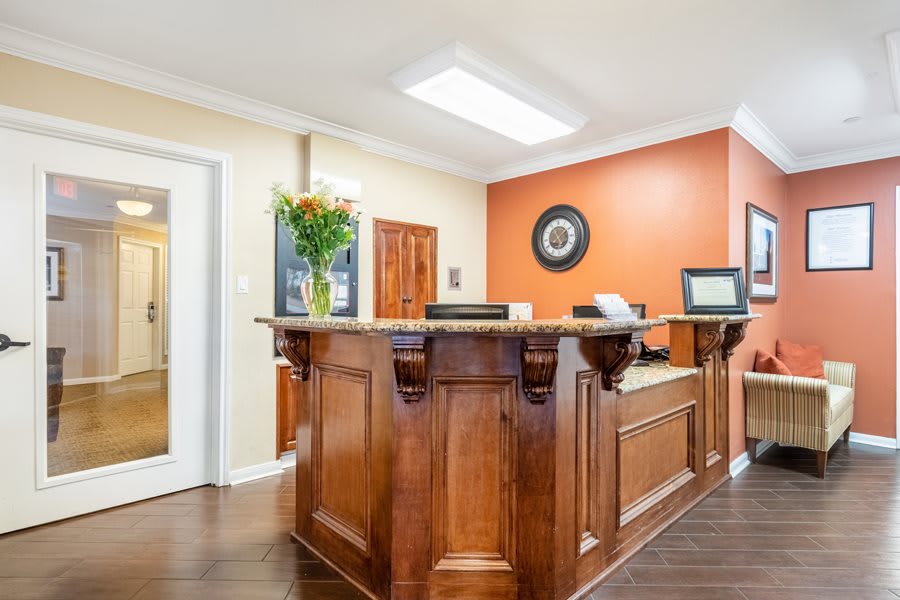 A well-organized reception area with a wooden desk and decorative elements.